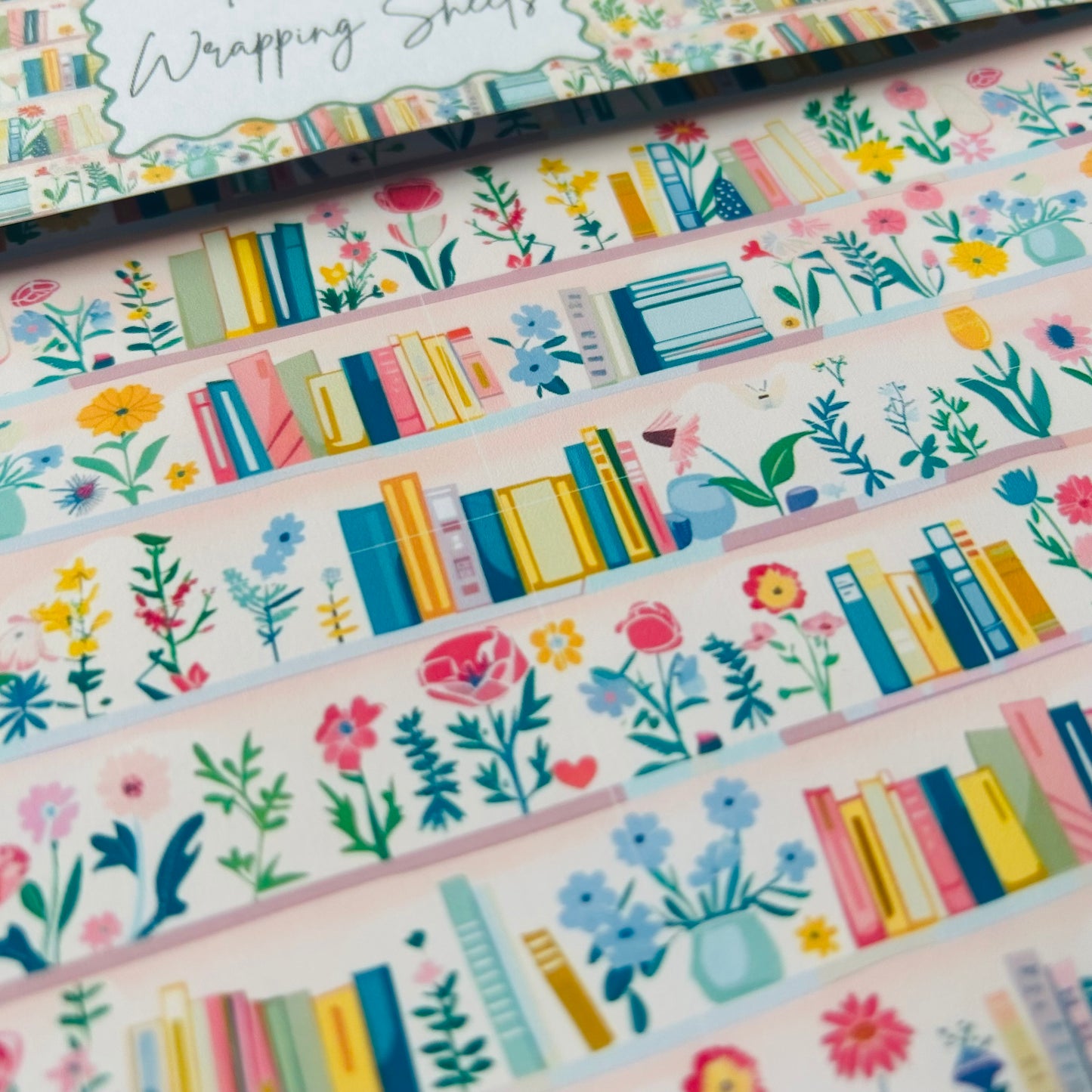 Set of colourful papers with book and floral designs on a white background.