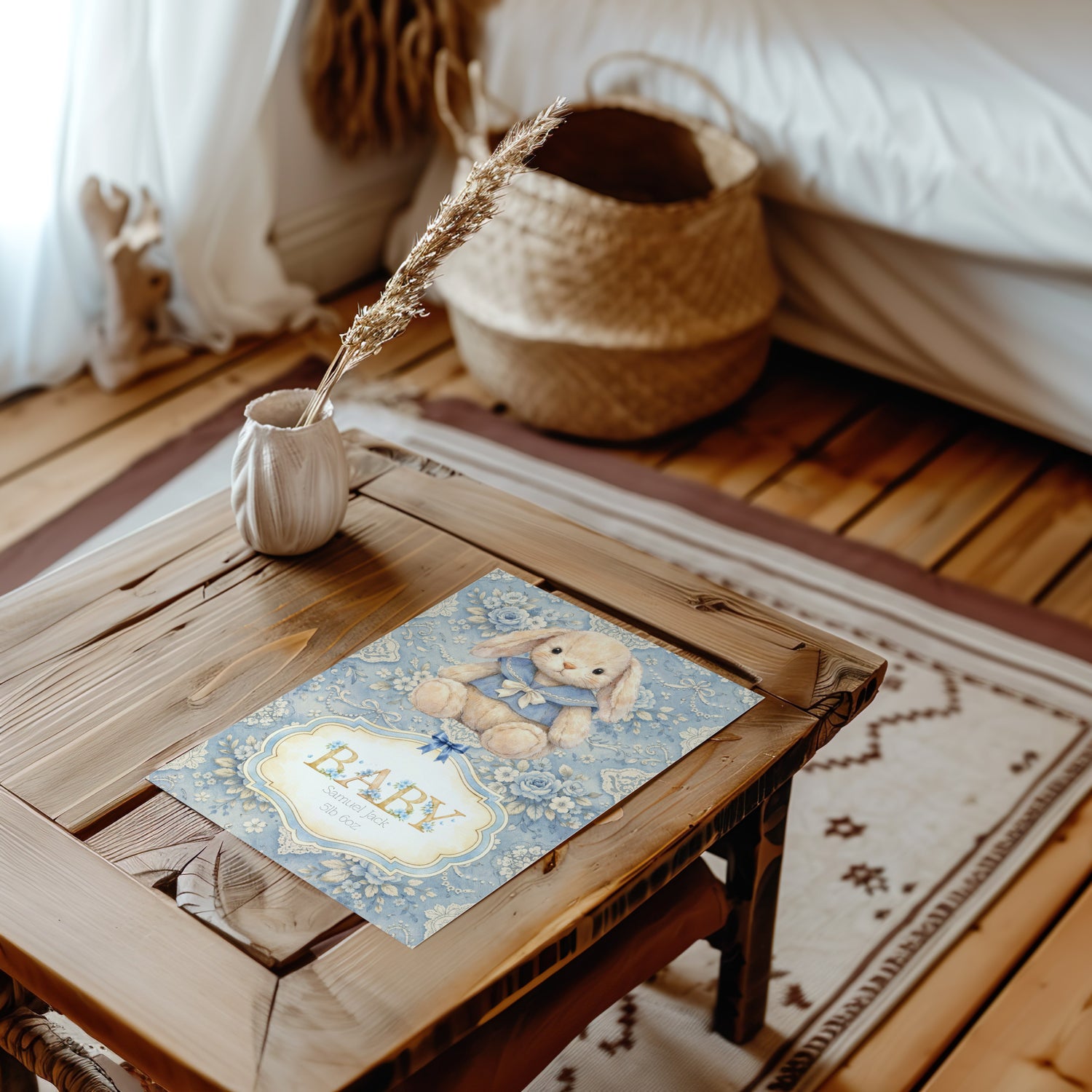 Wooden table with a decorative card featuring a baby shower design, surrounded by home decor elements.