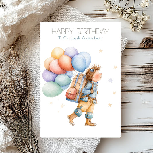 Birthday card with a child holding balloons on a textured surface with flowers.