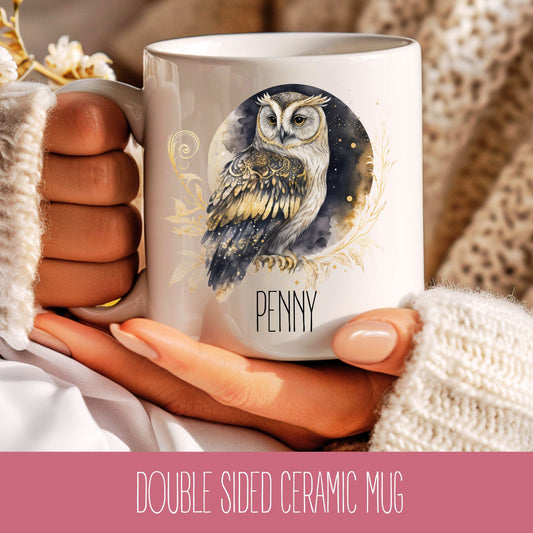 A person holding a white ceramic mug with a printed owl design and the name 'Penny' on it.