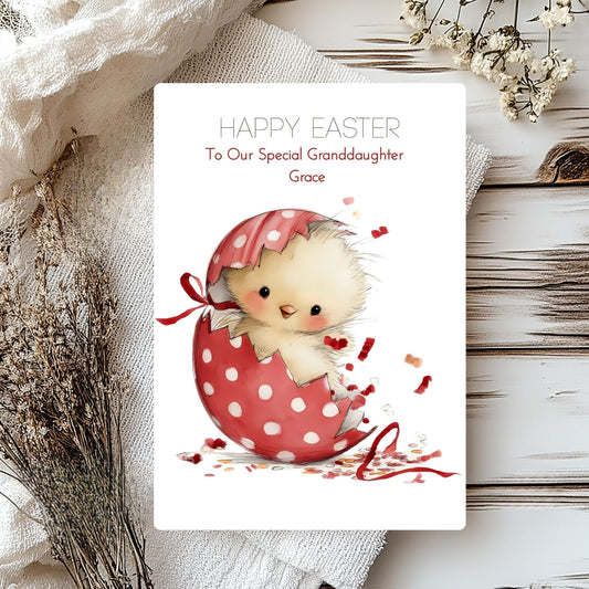 Easter card with a chick in a polka dot egg, surrounded by decorative elements on a wooden surface.