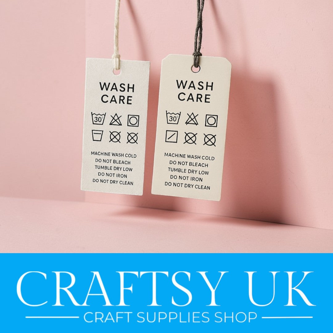 Two  sample wash care labels hanging against a pink background created by 'Craftsy UK' 