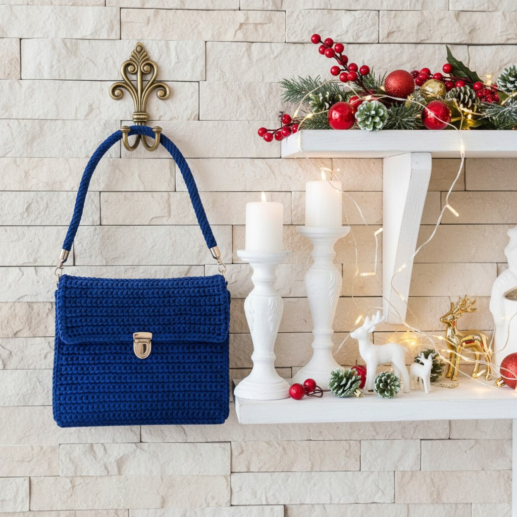 Blue handbag on a hook with a festive shelf decorated for Christmas.