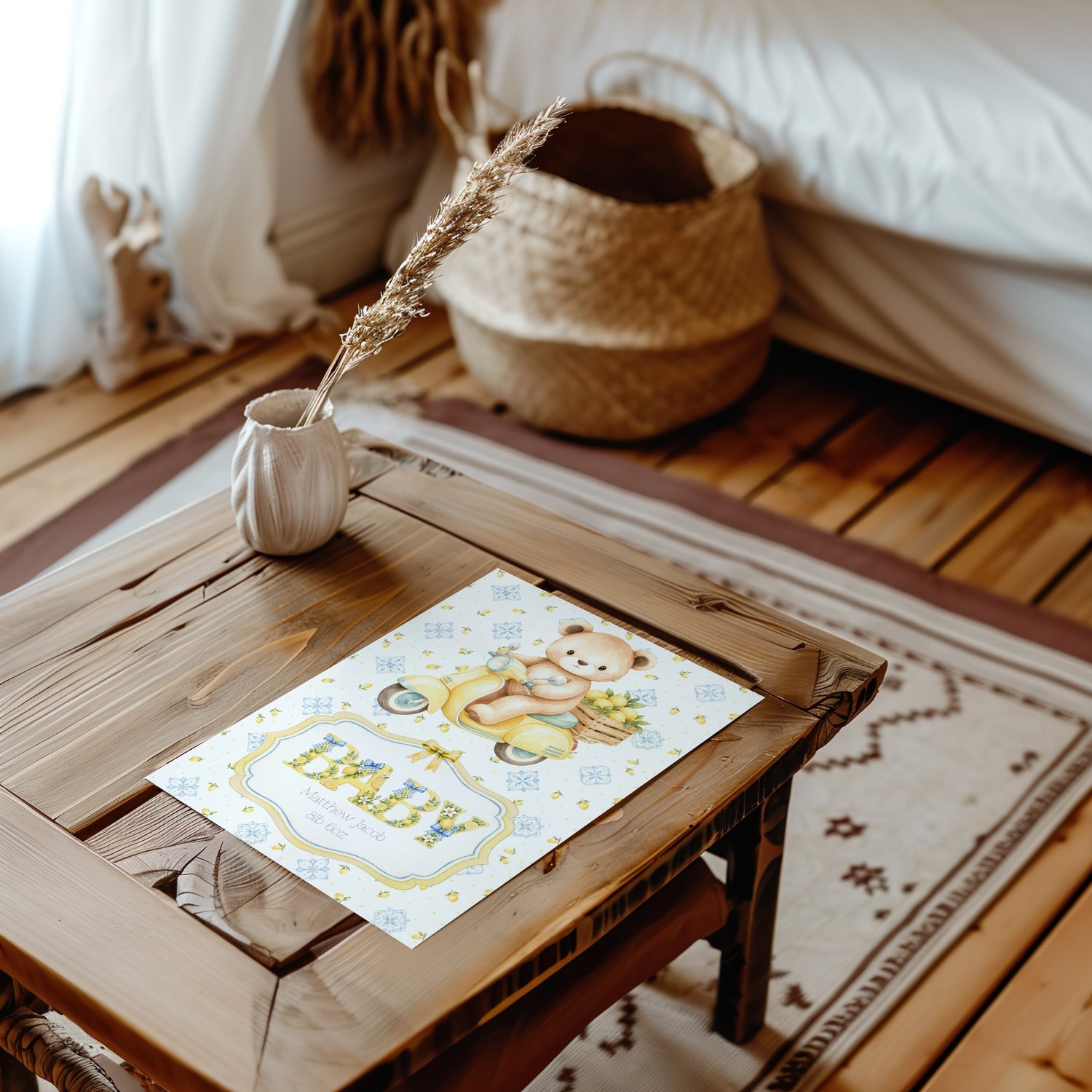 A baby card featuring a cute teddy bear and the word 'BABY' in stylish lettering, styled on a rustic wooden table in a cosy, warm-toned nursery setting.
