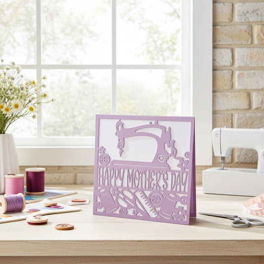 Purple 'Happy Mother's Day' card with sewing machine design on a sewing table.