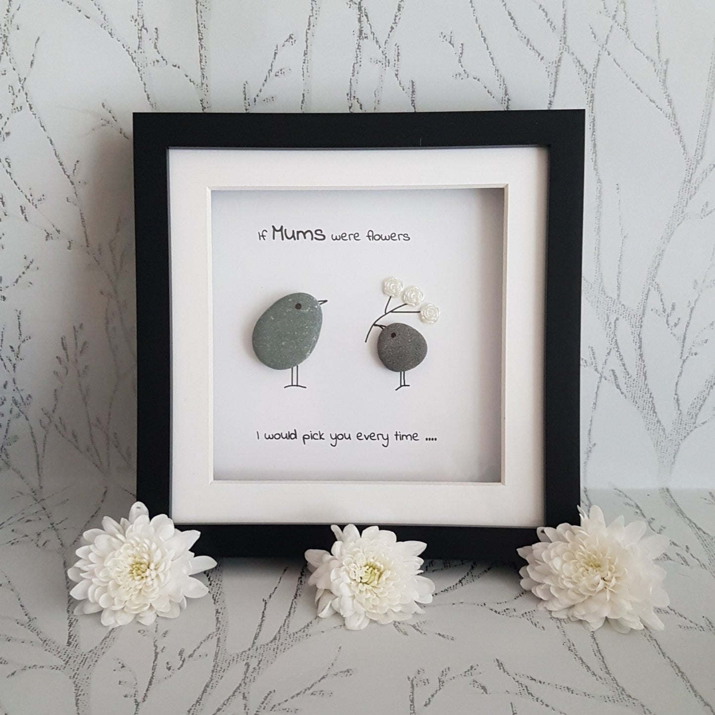 Pretty pebble art for mum on a tree branch background with flowers.