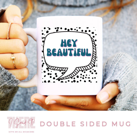 A person holding a white coffee mug with a double-sided print. The mug has text and a speech bubble graphic design, and is labeled as a 'Double sided mug' and 'Handmade unique gift'.