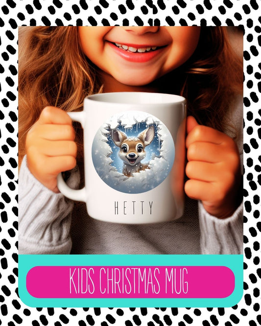 A child holding a white ceramic mug with a personalised deer design and the text 'HETTY' on it. The mug has a Christmas themed graphic with snowflakes and the text 'Kids Christmas Mug'.