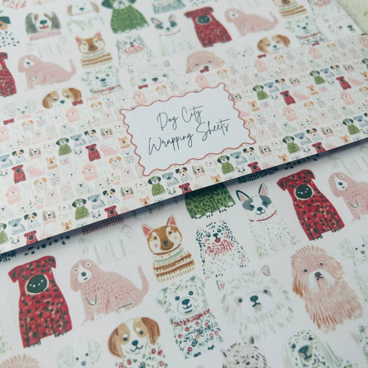 Dog-themed wrapping paper with various dog illustrations on a white background.