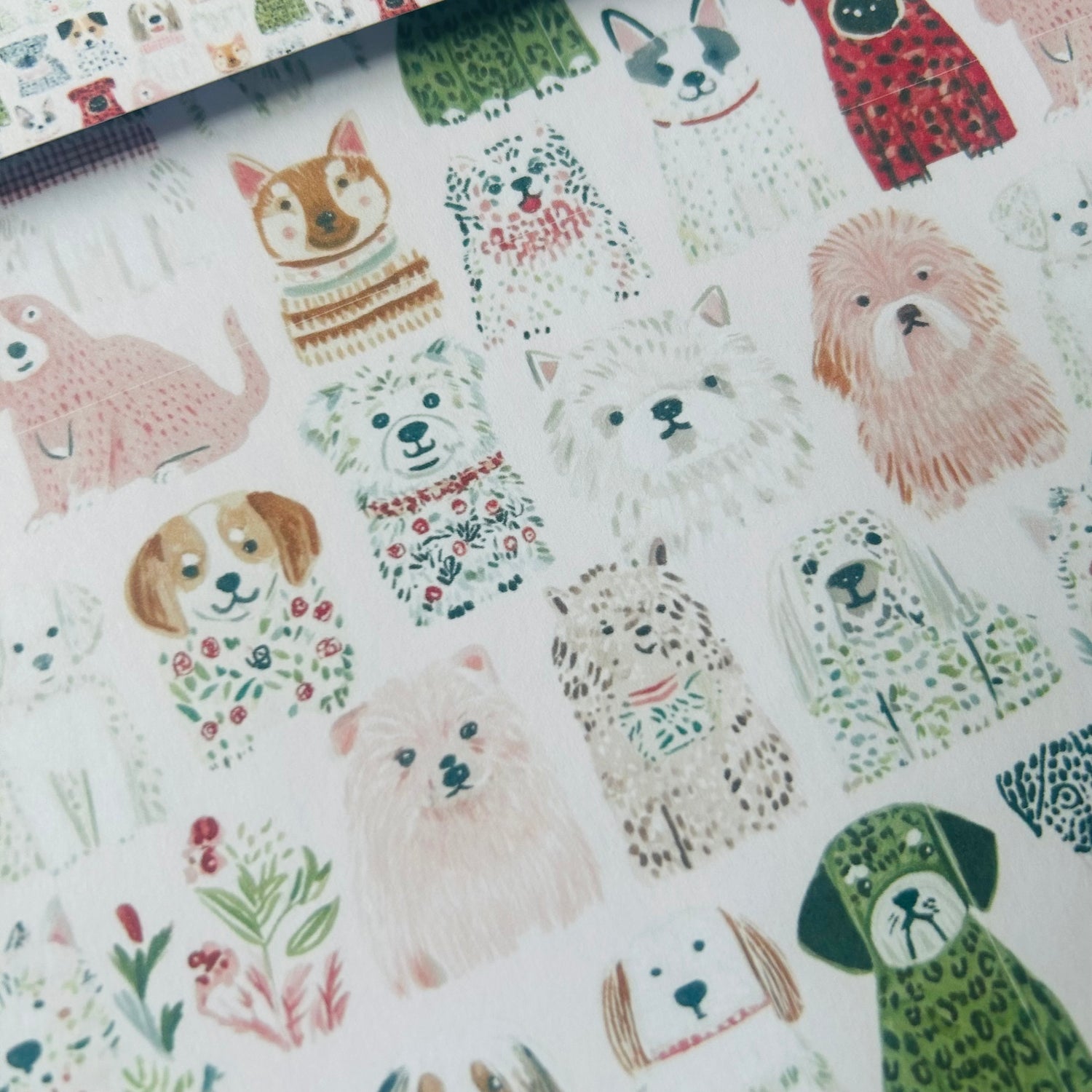 Patterned paper with illustrations of dogs and other animals on a white background