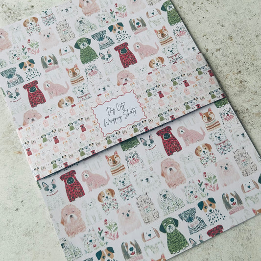 Two sheets of wrapping paper with dog pattern on a textured surface