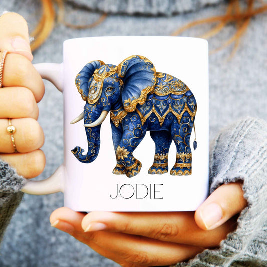 Mug with a decorative elephant design held by hands
