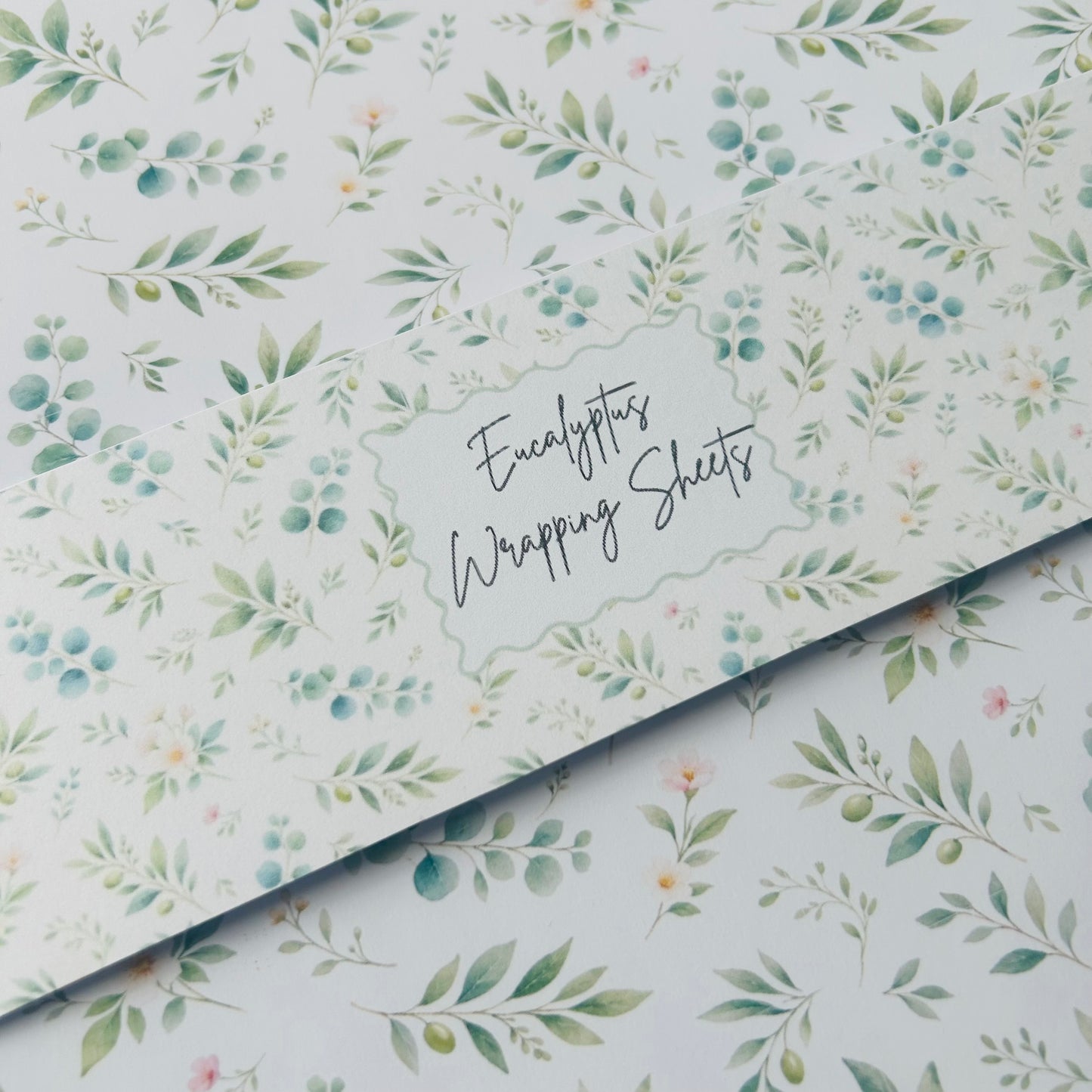 Eucalyptus wrapping sheets with a floral pattern on a white background