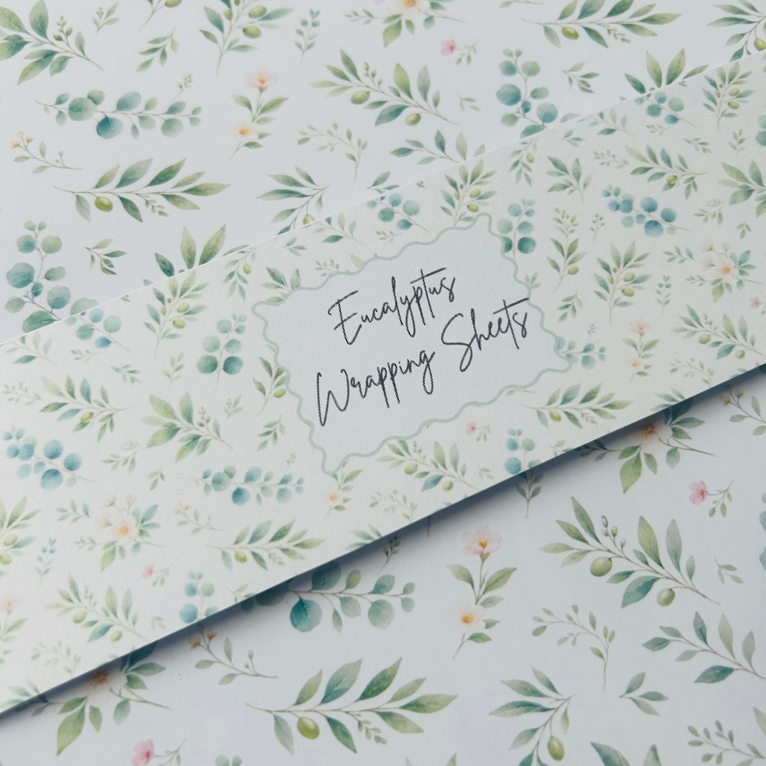 Eucalyptus wrapping sheets with a floral pattern on a white background