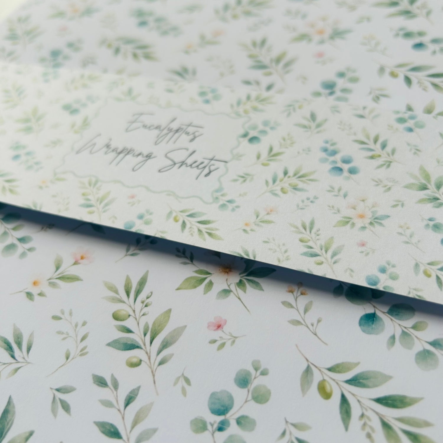 Floral patterned paper with 'Eucalyptus Wrapping Sheets' text on a white background