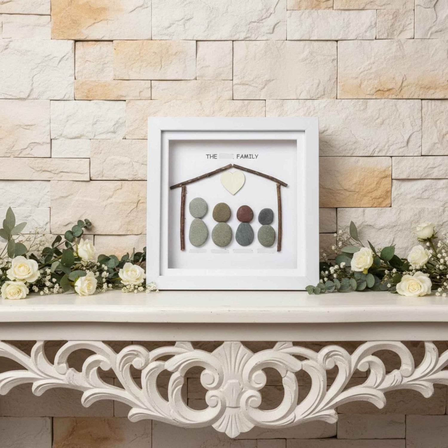 Decorative wall art with pebble family design on a stone wall background