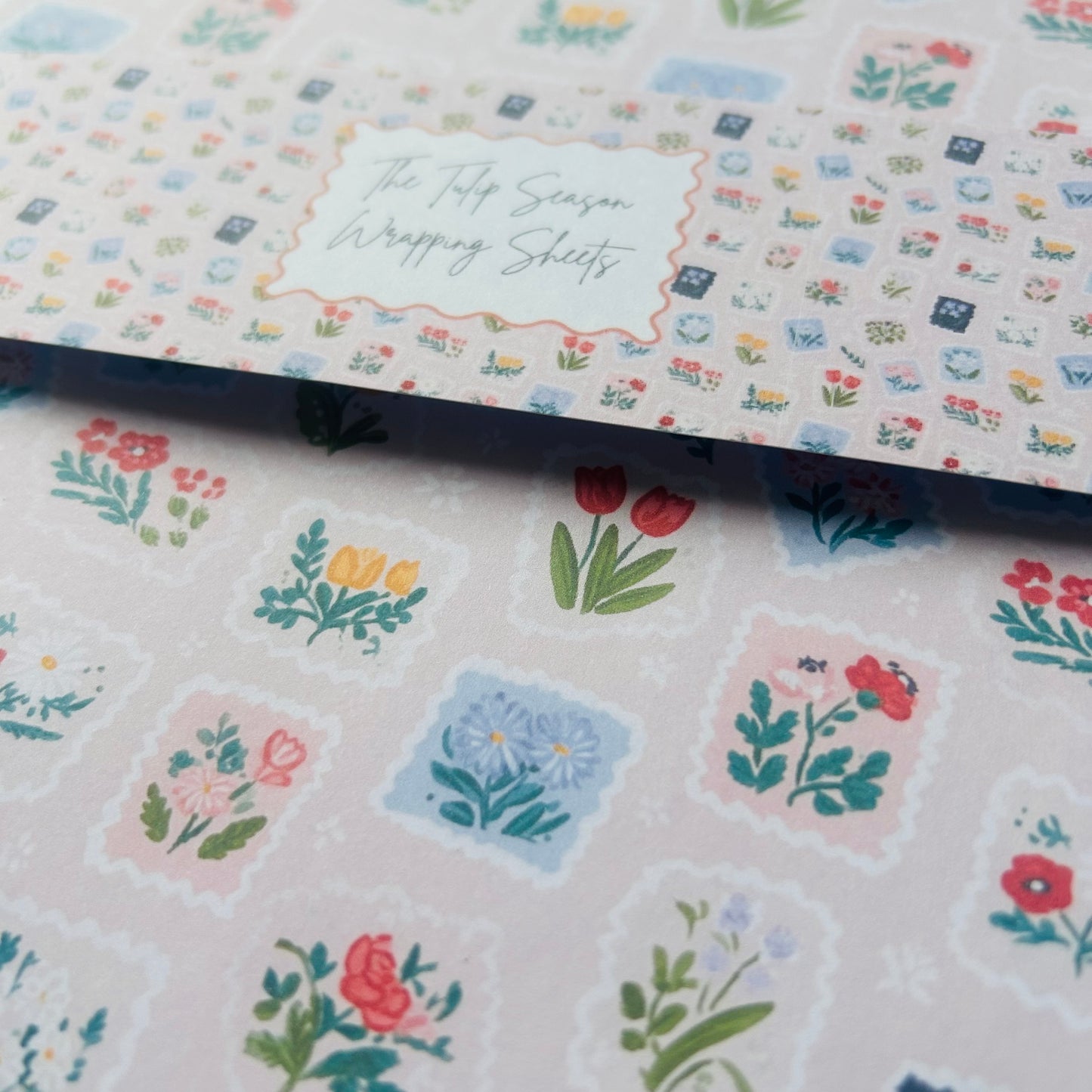 Floral wrapping paper with decorative stickers on a white background