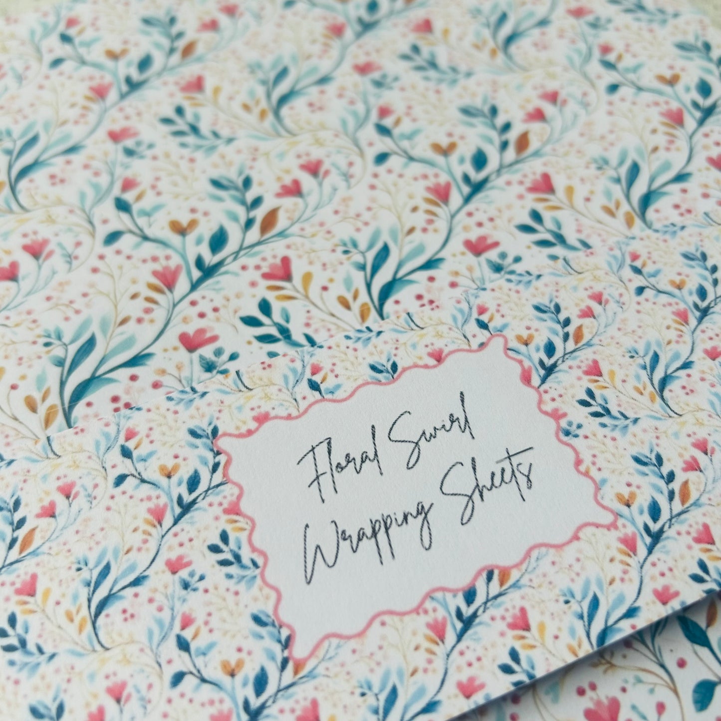 Floral patterned wrapping sheets with a label on a matching floral background