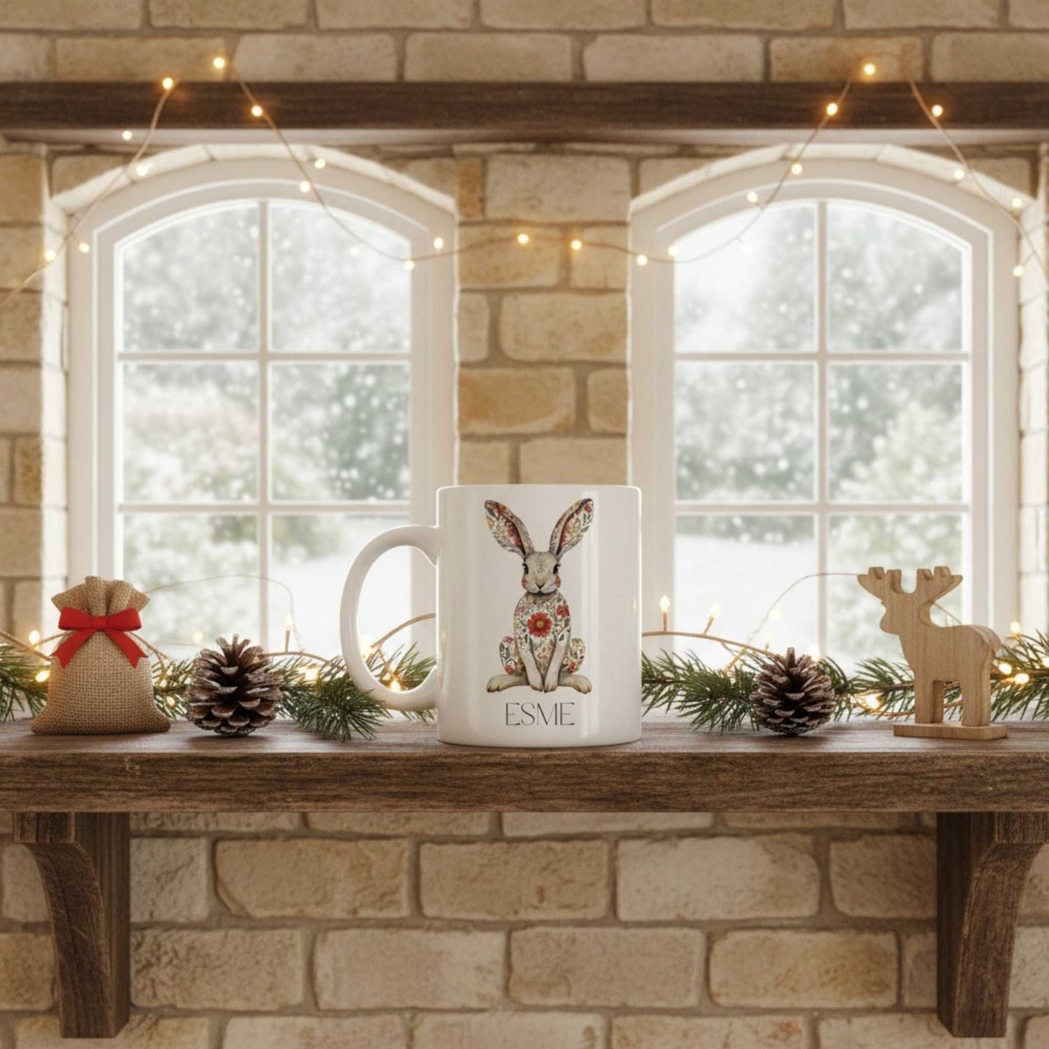 White mug with hare design on a wooden shelf against a stone wall with windows.