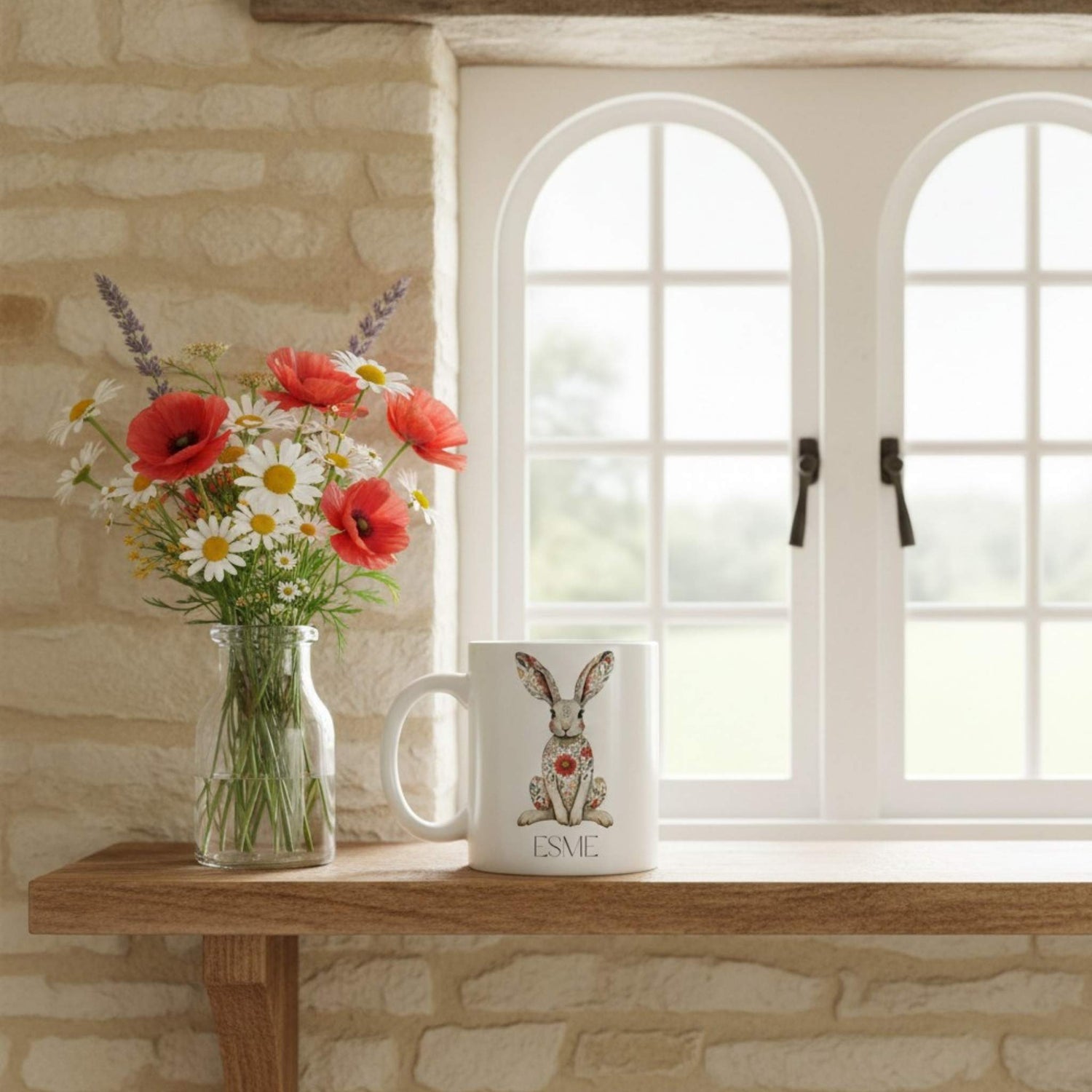 Mug with a hare design and flowers on a windowsill