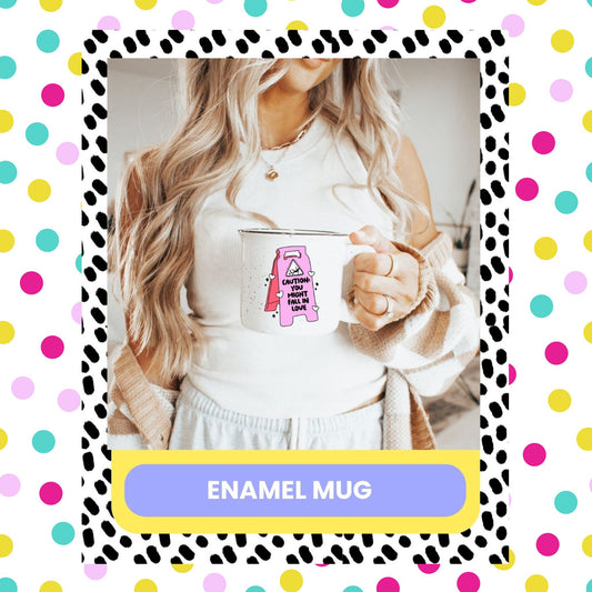 A person holding a pink and black enamel mug with a humorous text pattern.