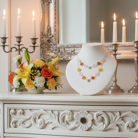 Decorative table setting with flowers, gemstone jewellery, and candles in a room.