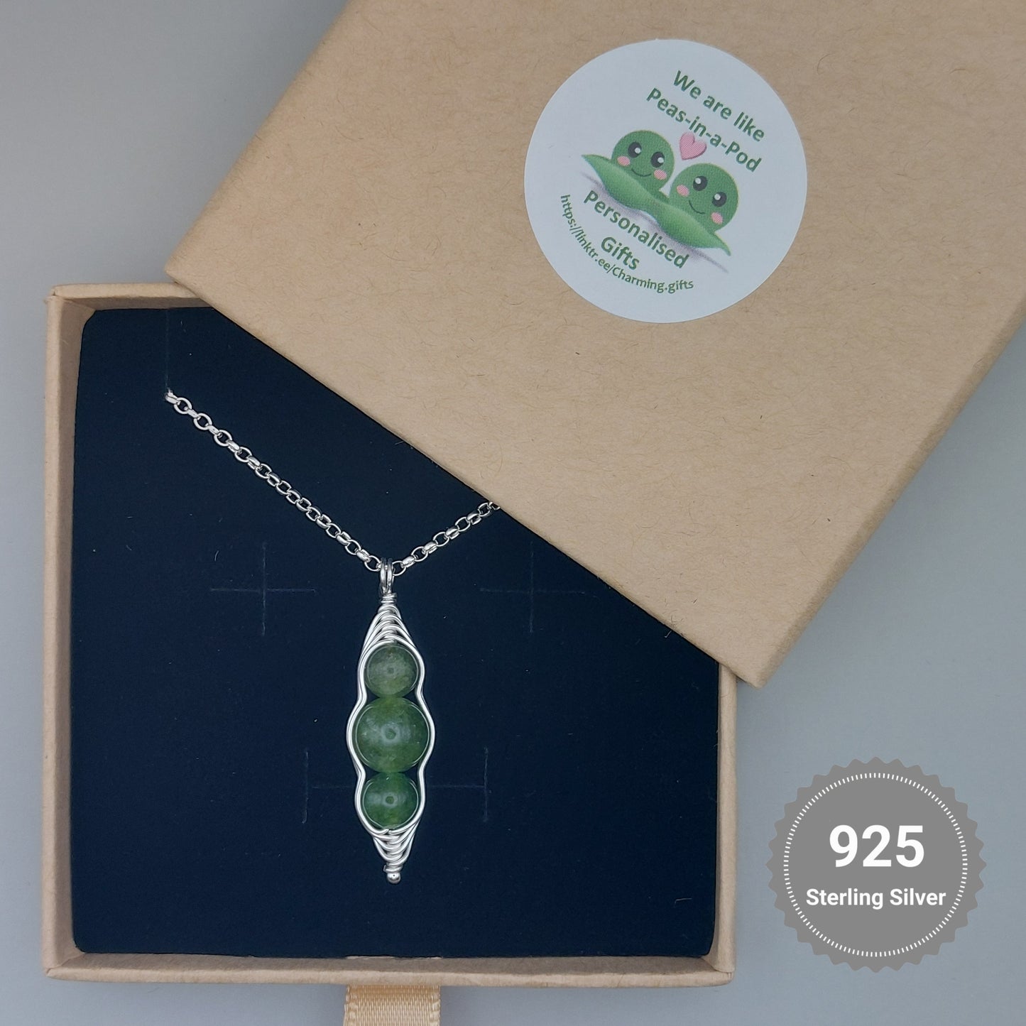 Green pea pod chain with three peas in a branded jewellery box