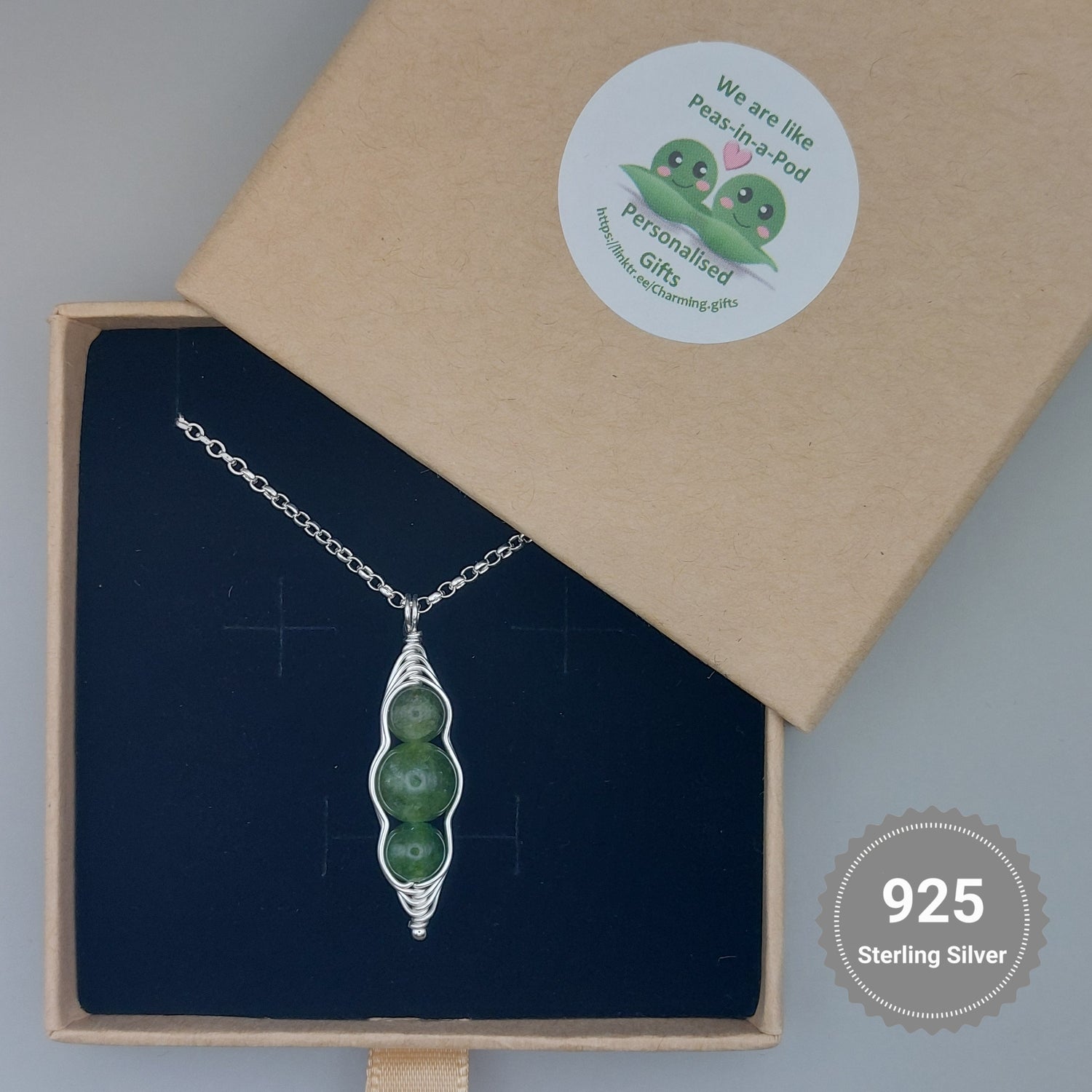 Green pea pod chain with three peas in a branded jewellery box