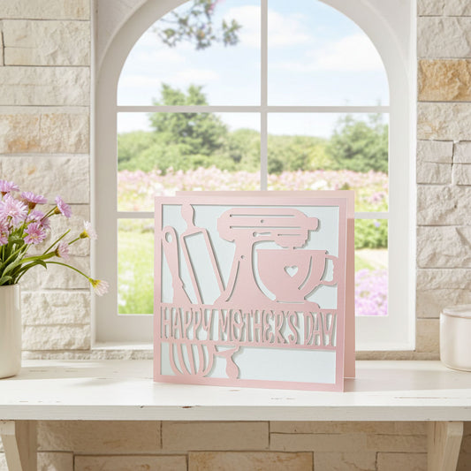 Pink baking card on a table with a window view of greenery