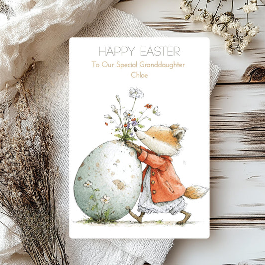 Greeting card with a fox holding flowers and an Easter egg, surrounded by decorative elements on a wooden surface.