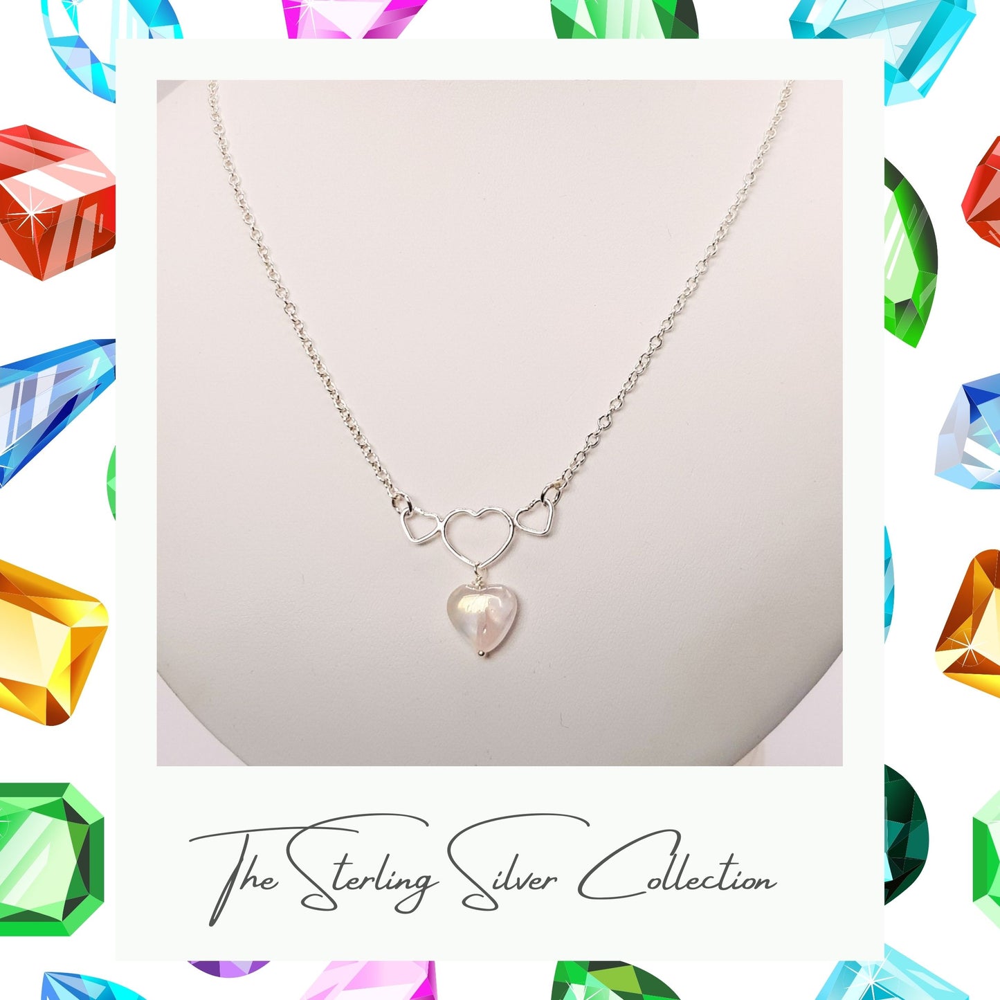 Heart necklace with sterling silver heart elements on a necklace stand.