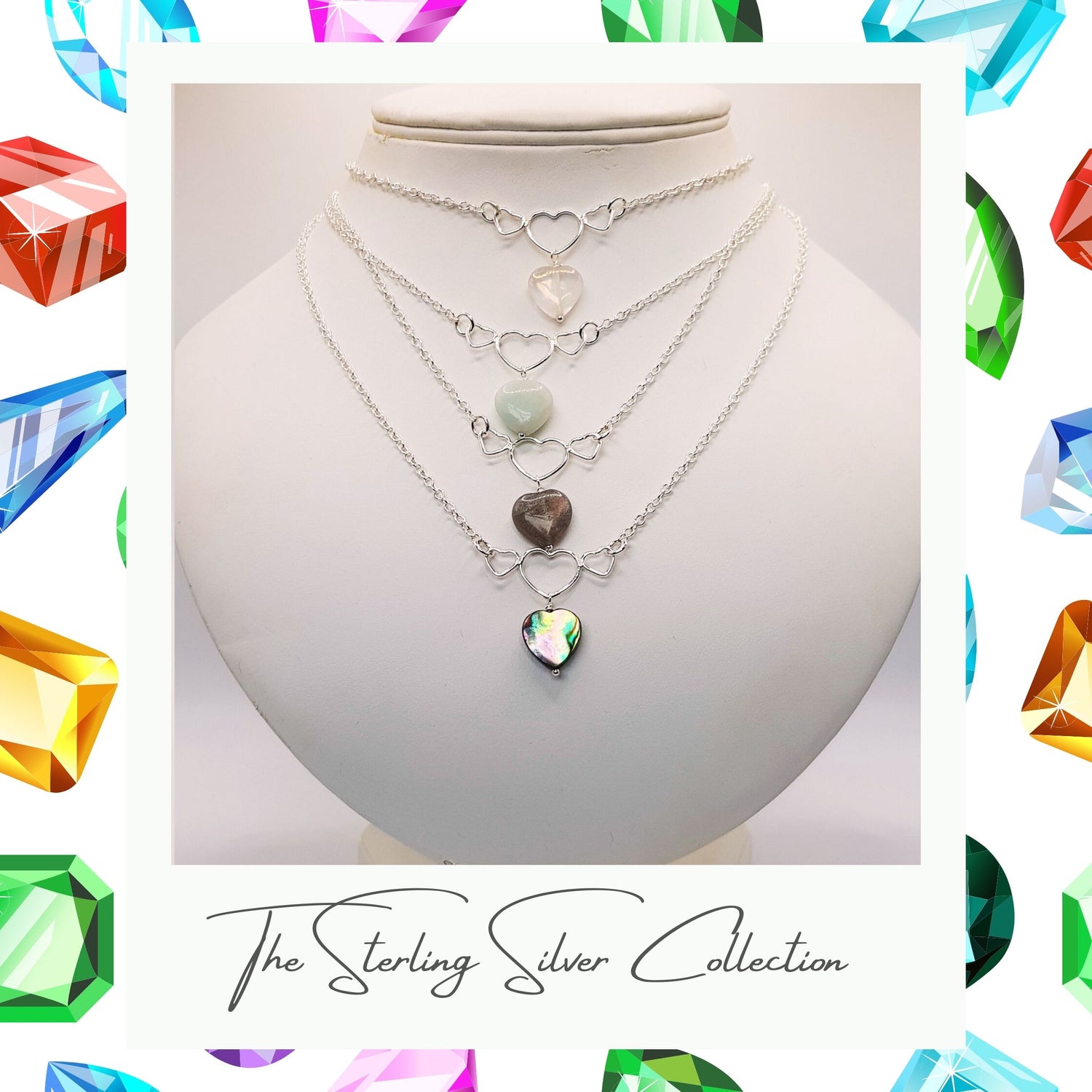 A sterling silver necklace with three heart-shaped pendants, featuring semi-precious stones.