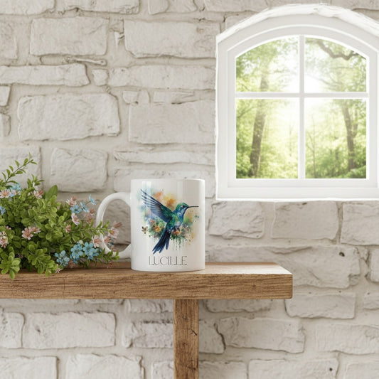 Mug with a colourful bird design on a wooden shelf against a stone wall with a window in the background.