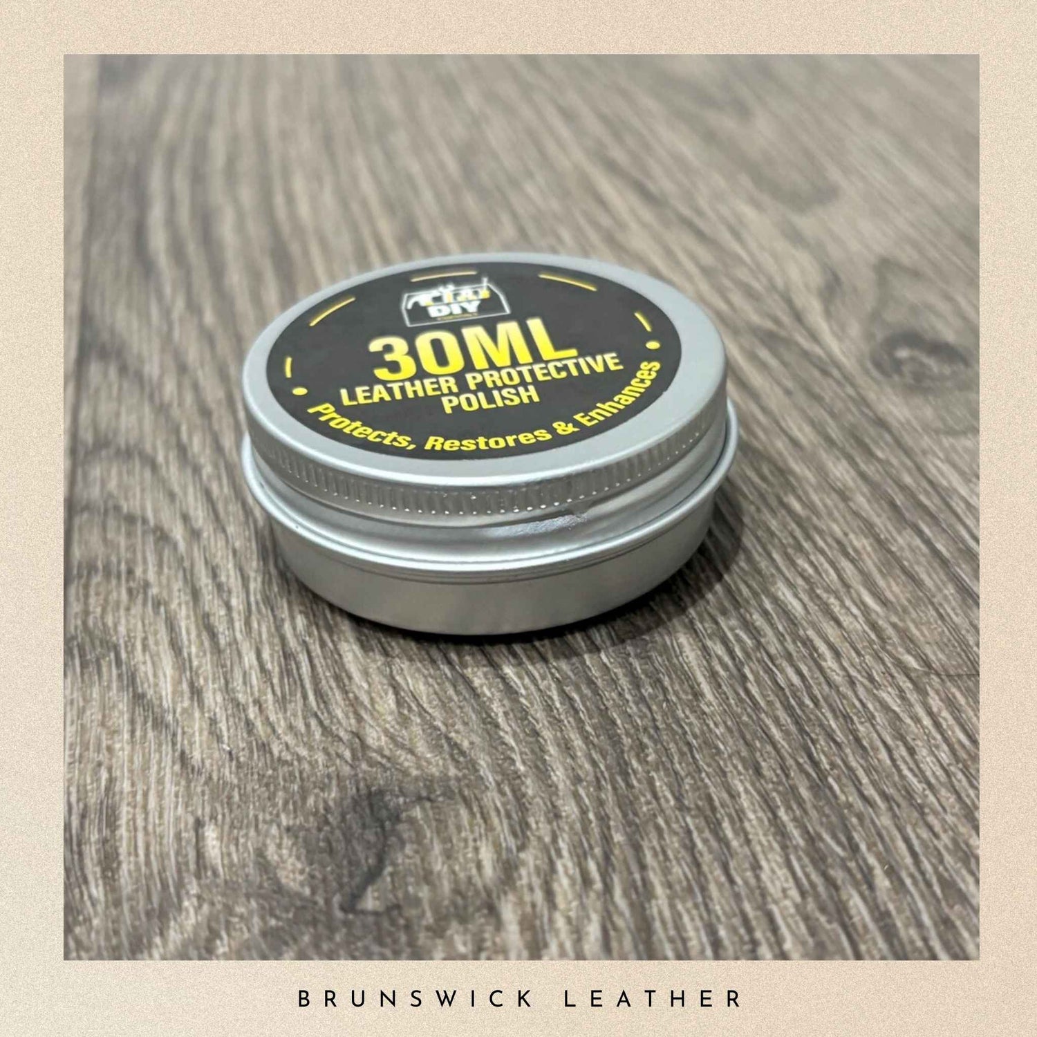 30ml leather protective polish container on a wooden surface with 'Brunswick Leather' branding.