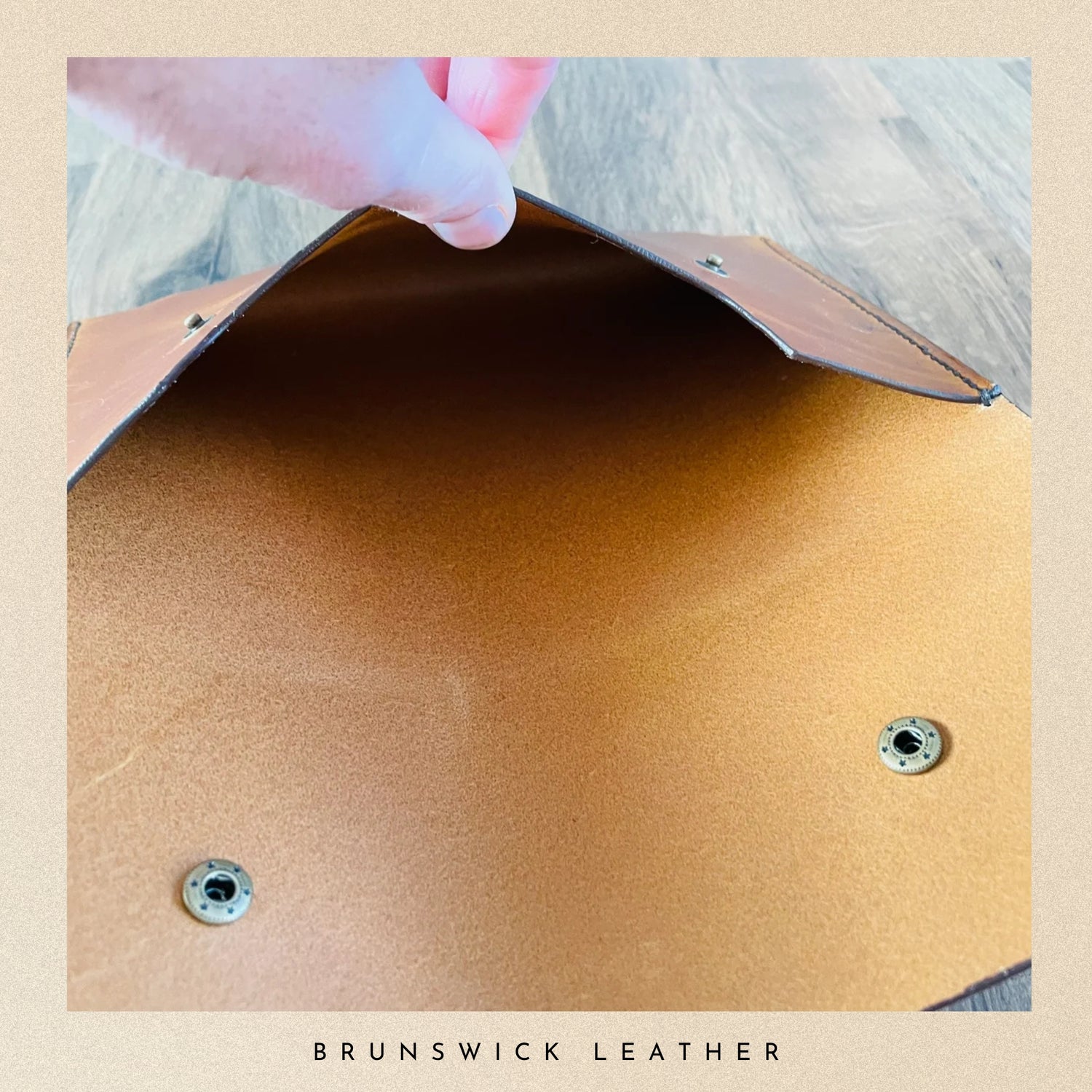 Close-up of brown leather surface with screws, labeled 'Brunswick Leather'.
