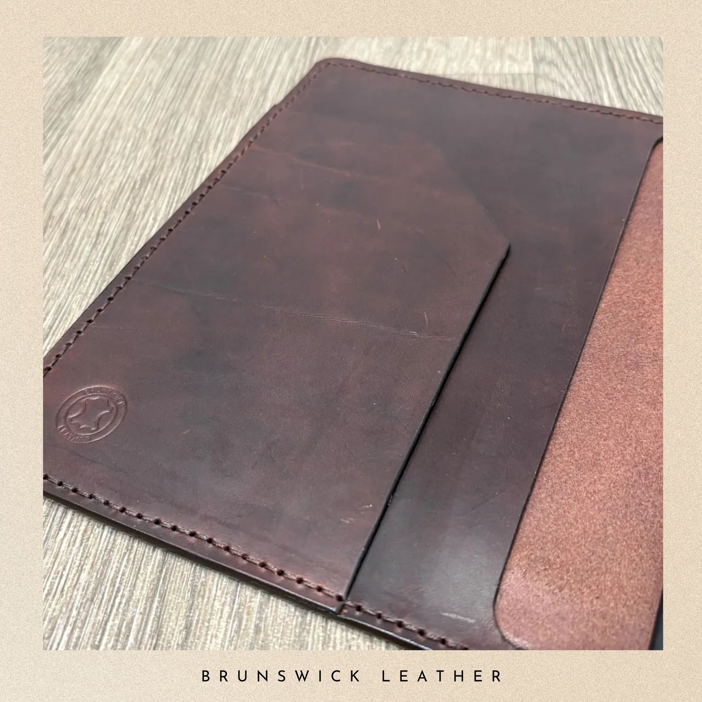 Brown leather sleeve on a textured surface with 'Brunswick Leather' branding.