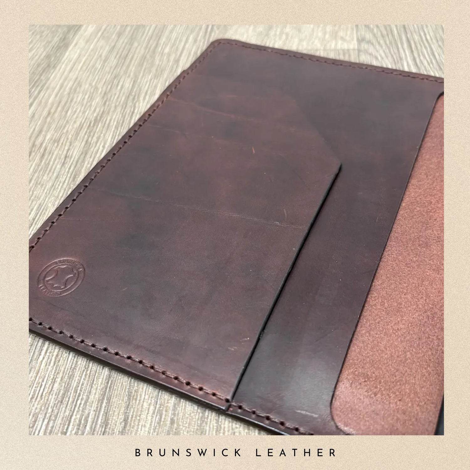 Brown leather sleeve on a textured surface with 'Brunswick Leather' branding.