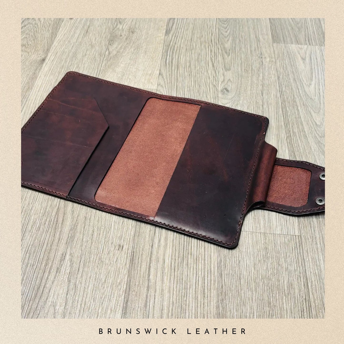 Brown leather wallet on a wooden surface with 'Brunswick Leather' branding.