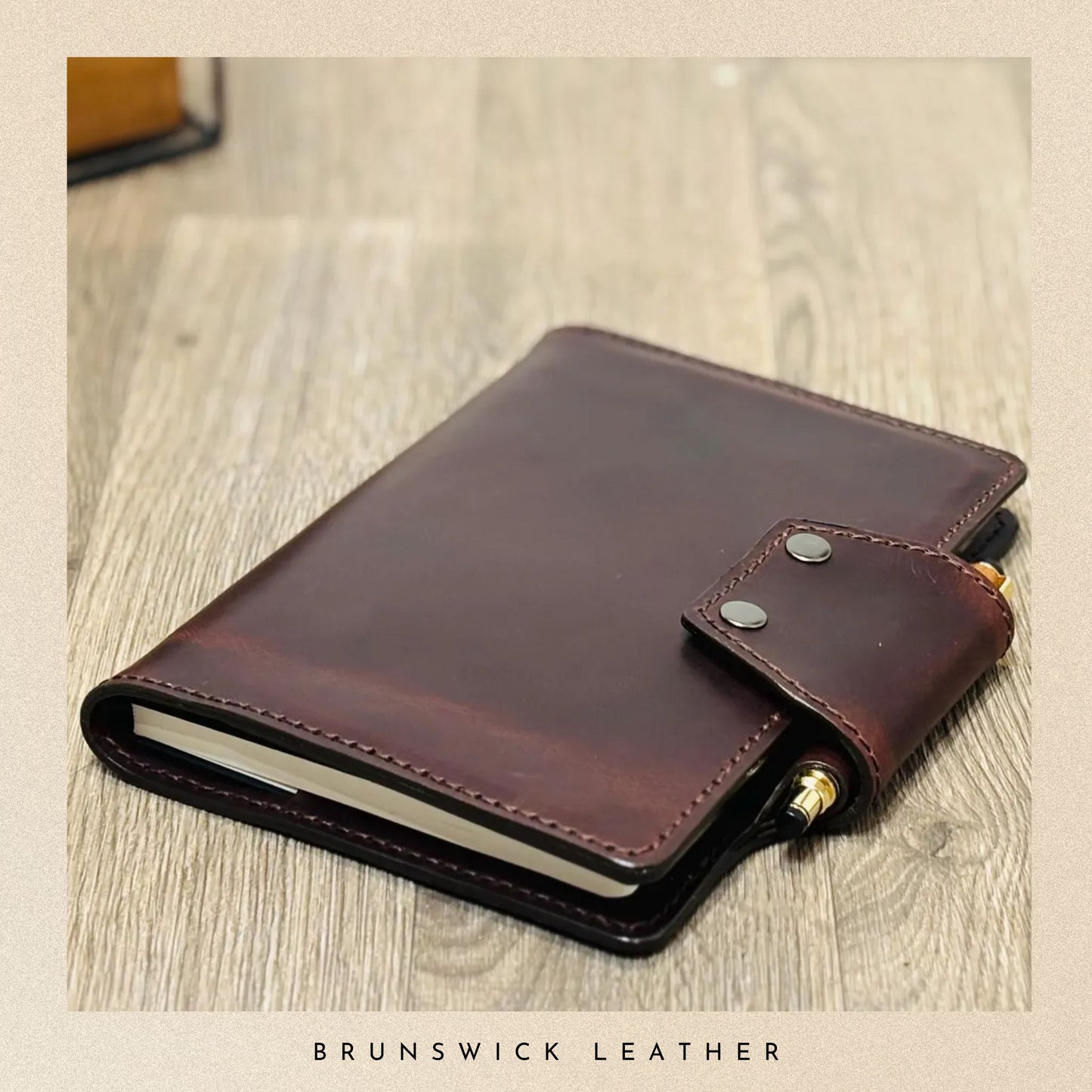 Brown leather wallet on a wooden surface with 'Brunswick Leather' branding.