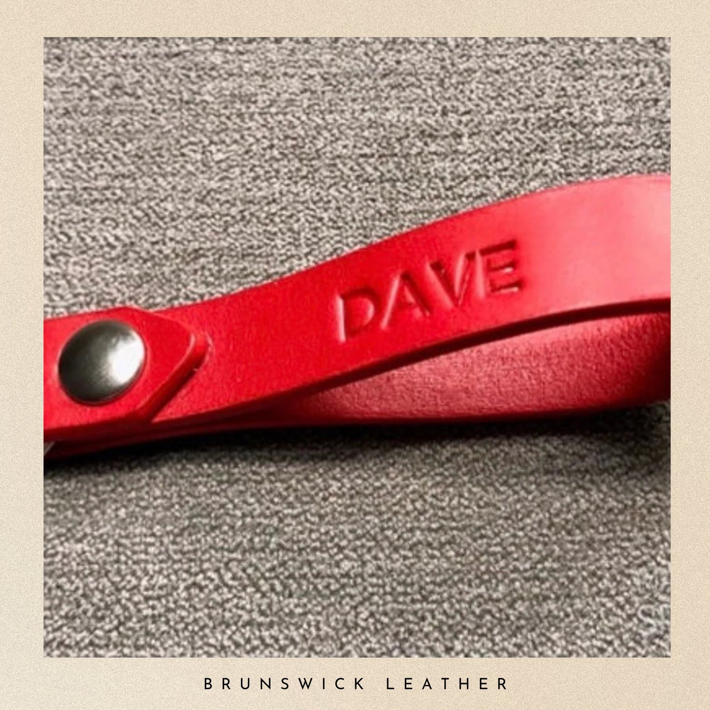 Red leather product with 'DAVE' embossed on a textured gray background, branded 'Brunswick Leather'.