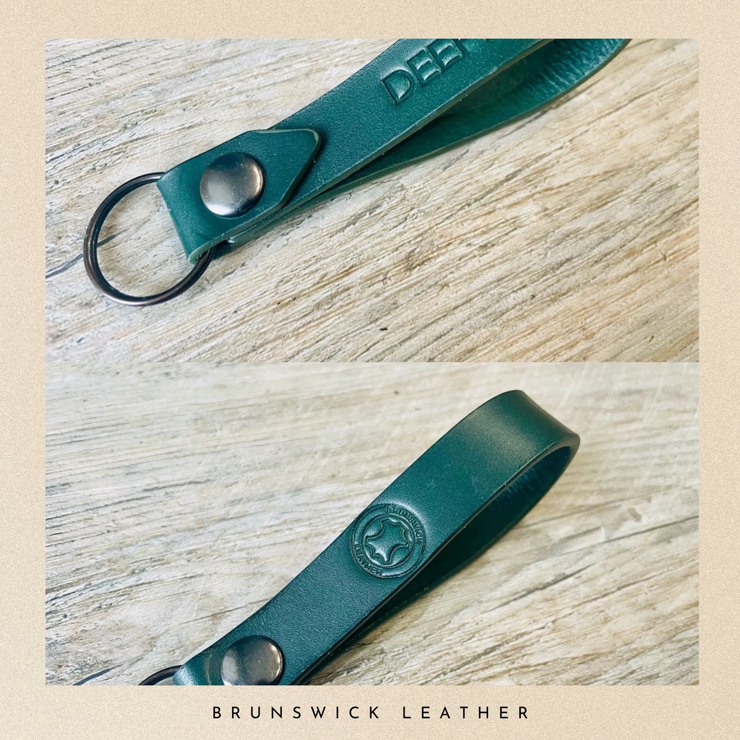 Green leather keychain with metal clip on a wooden surface, branded 'Brunswick Leather'.