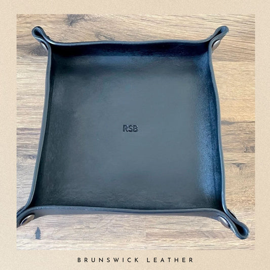 Blue leather tray with 'RSB' branding on a wooden surface, branded 'Brunswick Leather'.