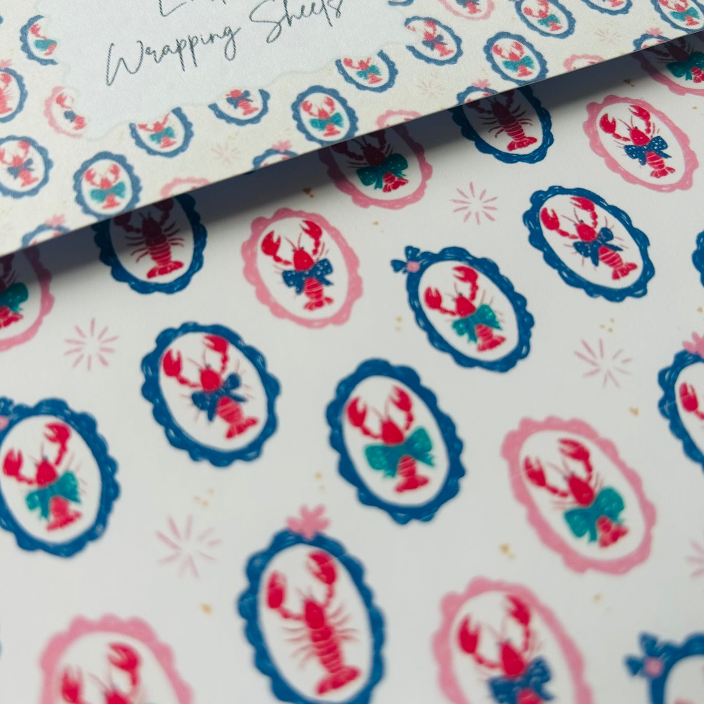 Patterned paper with lobster design on a white background