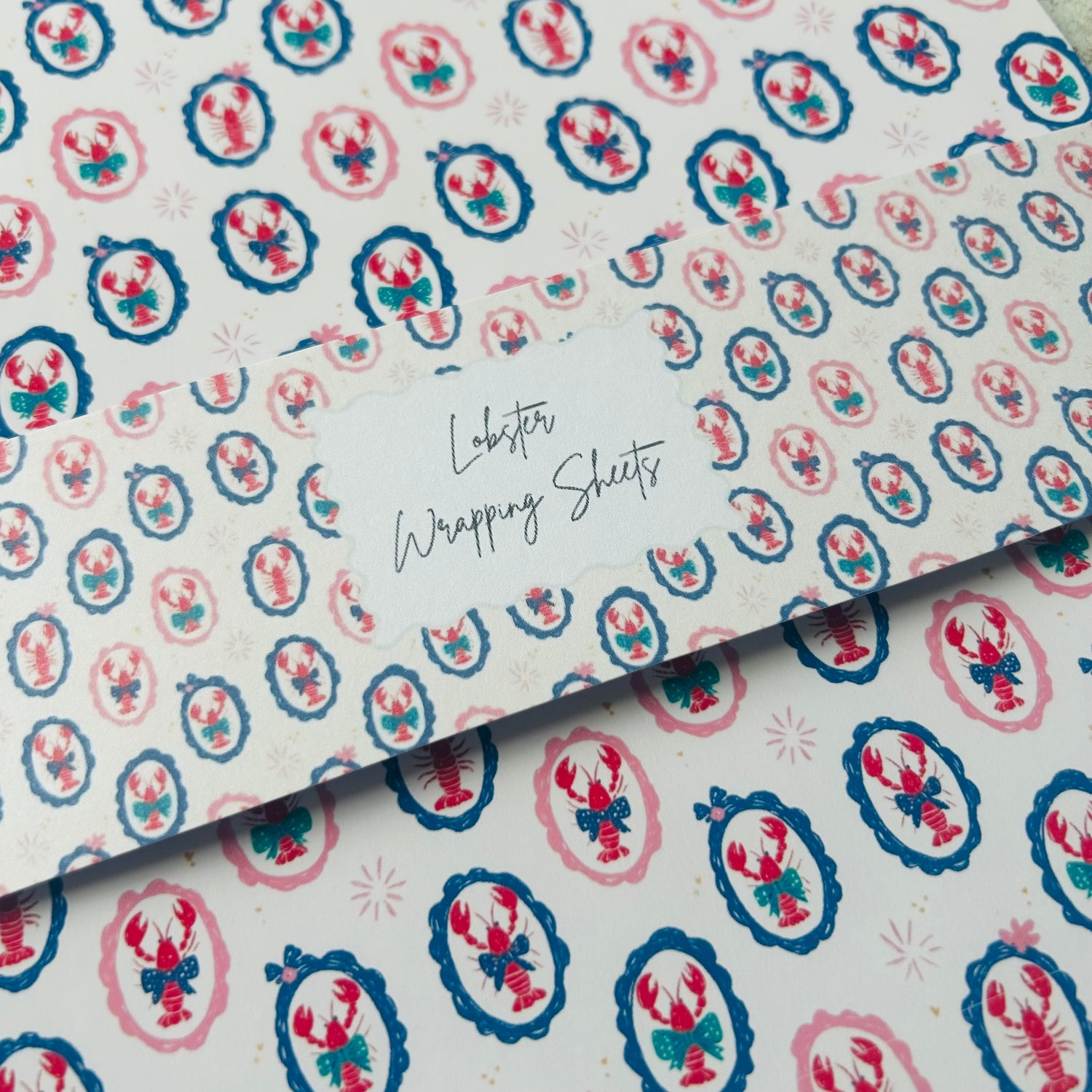 Patterned paper with lobster design and text 'Lobster Wrapping Sheets' on a white background.