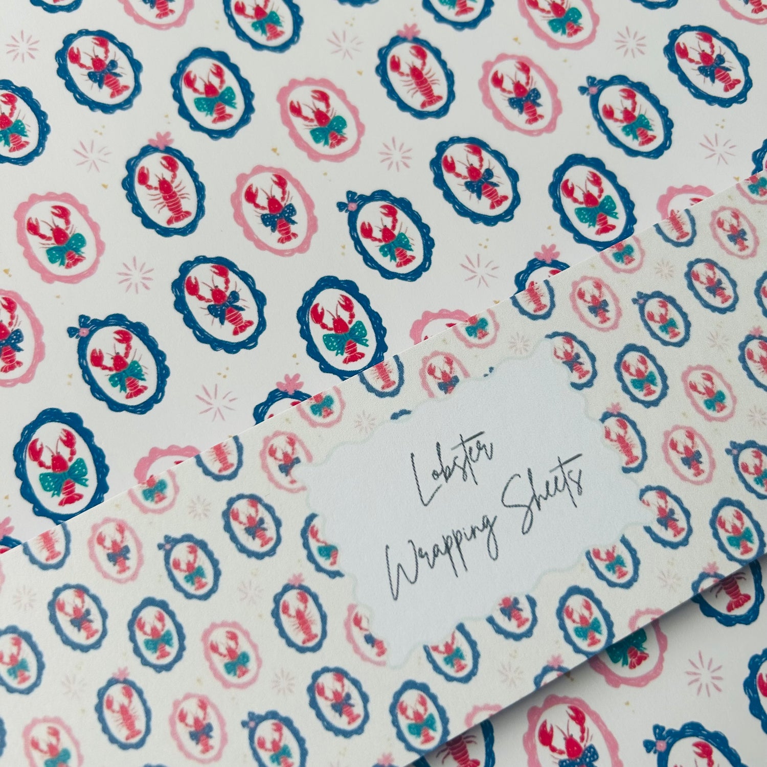 Patterned paper with lobster design and text 'Lobster Wrapping Sheets' on a white background