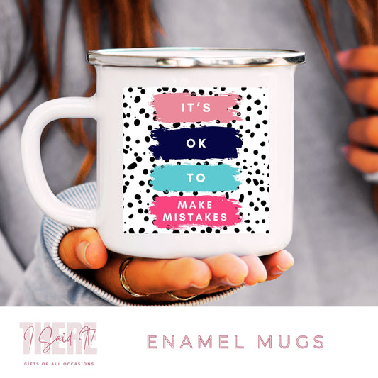 A white ceramic enamel camping mug with 'It's ok to make mistakes text and a spotted print pattern.