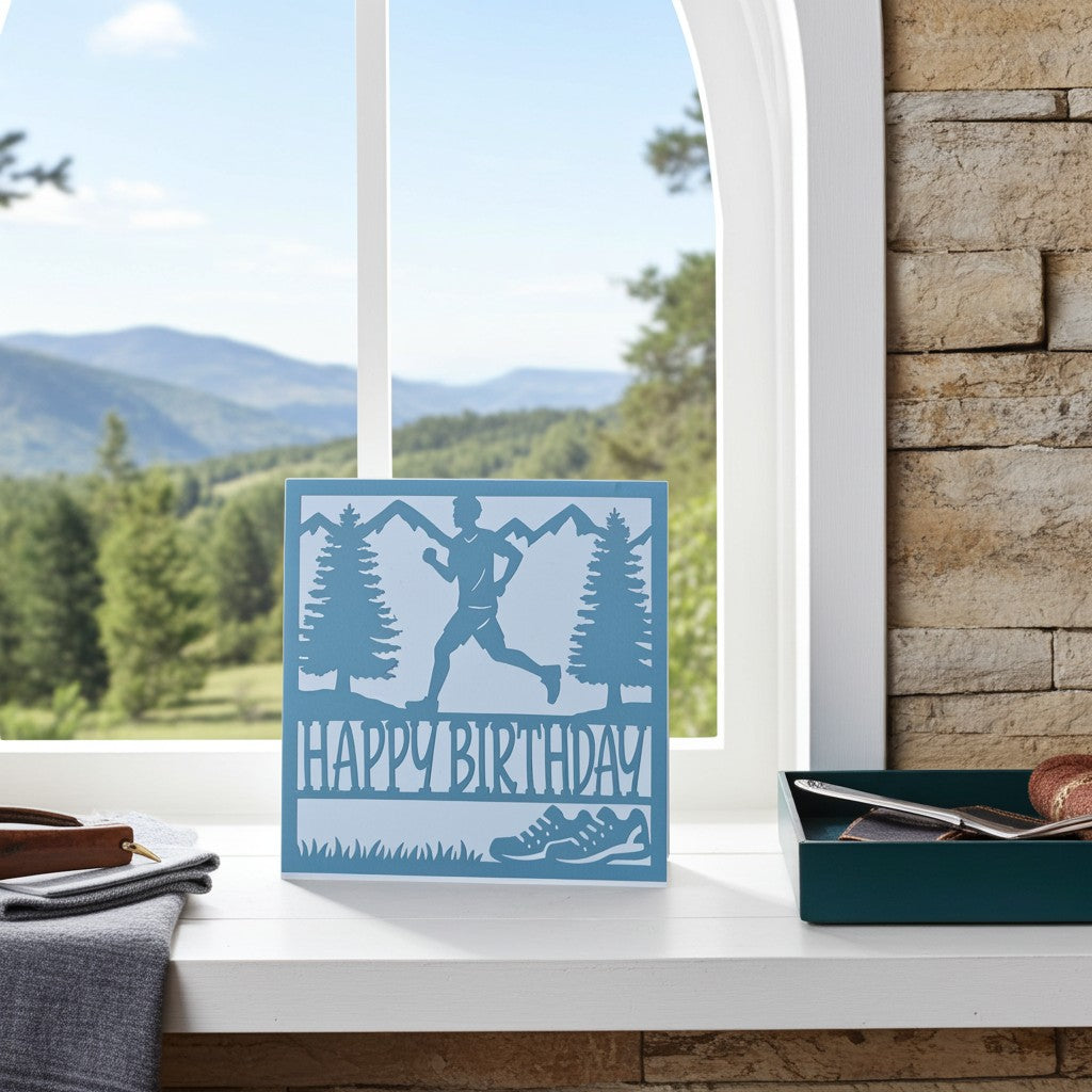Male runner card on a window sill with mountains outside the window behind.