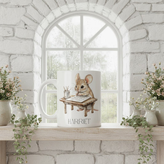 Mug with a design of a mouse named Harriet on a windowsill with decorative plants.