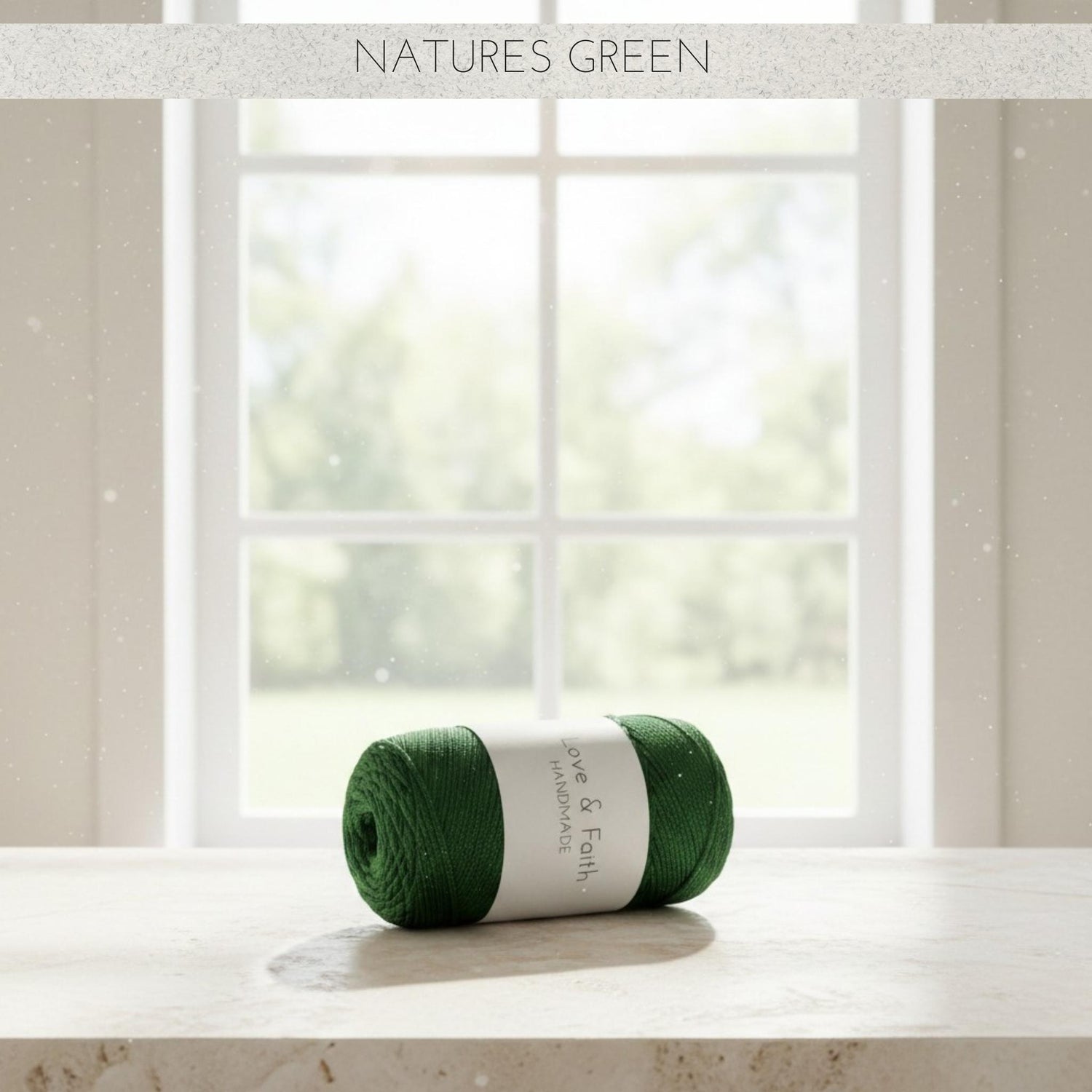 Green skein of yarn on a windowsill with 'Natures Green' text above.