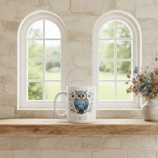 Mug with owl design on a windowsill with natural light